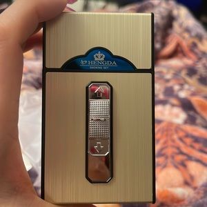 Gold/Black Reusable Cigrette Box with built in electric lighter.Hard case.